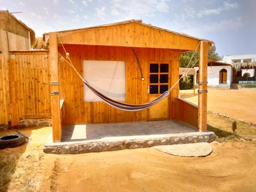 a building with a hammock outside of it at Mountain Sinai camp in Wāsiţ