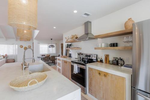a kitchen with a counter top with a refrigerator at L'Escape Joshua Tree in Joshua Tree