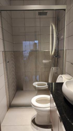 a bathroom with a shower with a toilet and a sink at Beautiful and central apartment in Tarija