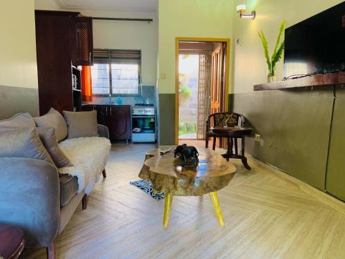 a living room with a couch and a coffee table at Pleasant Places in Kabubu