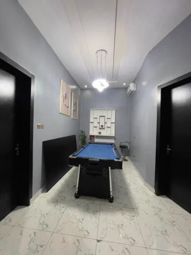 a room with a ping pong table in the middle at Sylvia Homes in Ibeju