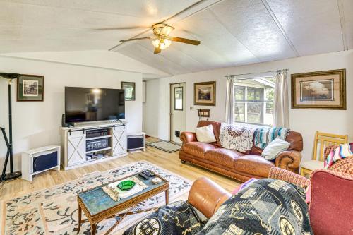 a living room with a couch and a table at 2 Mi to World Equestrian Center Gem with Large Yard in Ocala