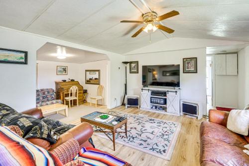 a living room with a couch and a ceiling fan at 2 Mi to World Equestrian Center Gem with Large Yard in Ocala
