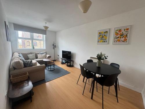 a living room with a couch and a table at 2 bed - 2 bath, gated parking, M62 J27 in Morley