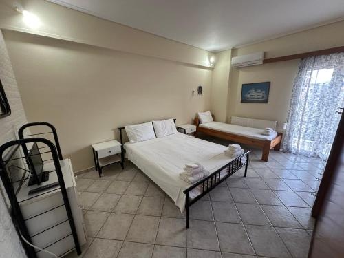 a bedroom with a bed and a couch in it at Mariangela Apartments in Lixouri