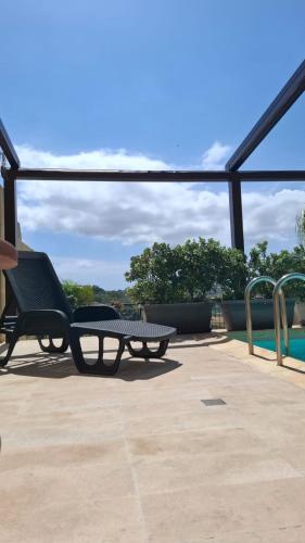 a patio with a bench and a table and a pool at Aurelia Gozo Boutique BnB in Xagħra