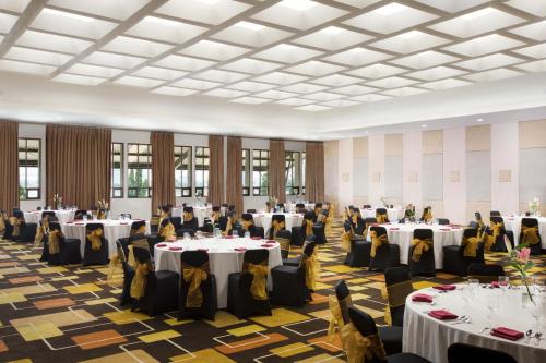 a banquet hall with tables and people sitting at them at Lemo Hotel Serpong in Serpong