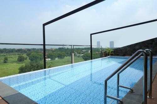 a swimming pool on top of a building at Lemo Hotel Serpong in Serpong