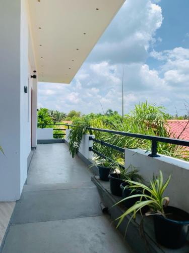 a balcony of a house with potted plants at Anukama Resort in Nilaveli