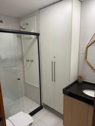 a bathroom with a shower and a sink at Malia Beach in Ipojuca