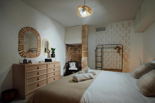 a bedroom with a bed and a dresser and a mirror at Senglea town house in Senglea