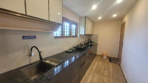 a kitchen with a sink and a counter top at NewCastle Holidays Resorts-Entire Property 5 Bedrooms-Great Mountain & River View-Between Munnar & Idukki with Kitchen in Idukki