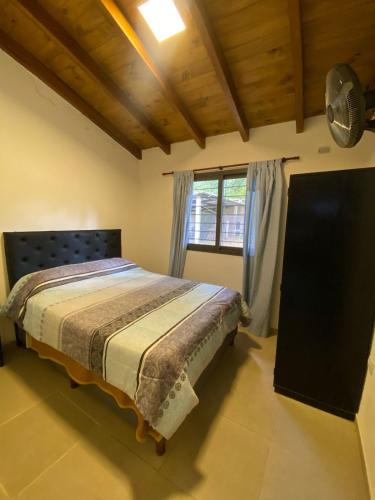 a bedroom with a bed and a window at Villa Simona in Santa Rosa de Calamuchita