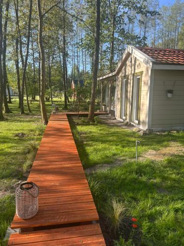 a wooden walkway in front of a house at Łąckówka Mazury in Świętajno