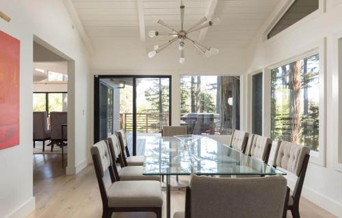a dining room with a glass table and chairs at LUX Private Modern Villa With Pool Spa & Dogs OK in Calistoga