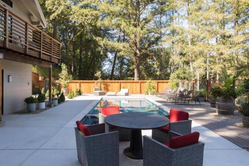 a patio with a table and chairs and a pool at LUX Private Modern Villa With Pool Spa & Dogs OK in Calistoga