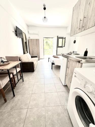 a kitchen and living room with a washer and dryer at Mani Spot in Areopolis