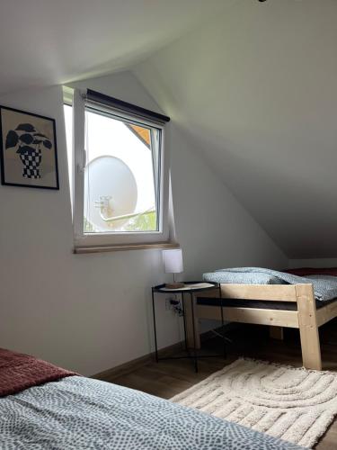 a bedroom with a bed and a window at Baza na Roztoczu - domek w Majdanie Sopockim in Majdan Sopocki