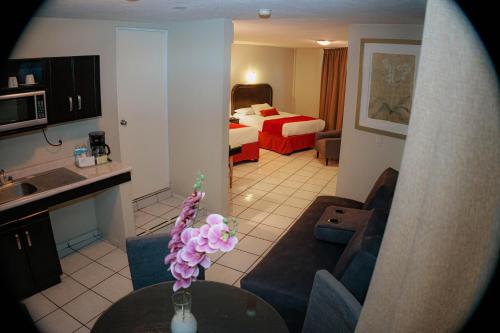a living room with a couch and a room with a bed at Howard Johnson by Wyndham Guanajuato Leon Avenida in León