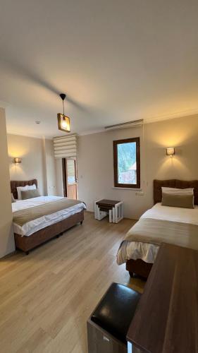 a hotel room with two beds and a window at Valoria Hotel in Uzungöl