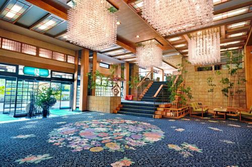 a lobby with a large rug on the floor of a building at Fujikawaguchiko Onsen Konanso in Fujikawaguchiko