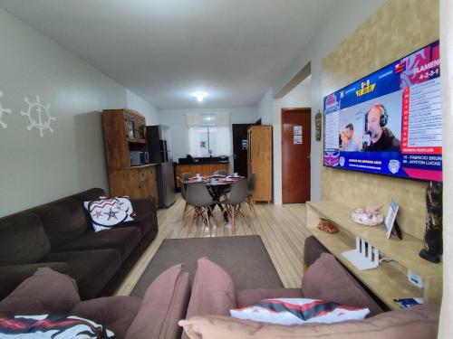 a living room with a couch and a table at Sobrado Lar Doce Mar Itapoá 100m from the Sea in Itapoa