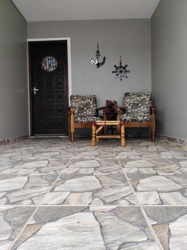 a room with a door and a couch and a table at Sobrado Lar Doce Mar Itapoá 100m from the Sea in Itapoa