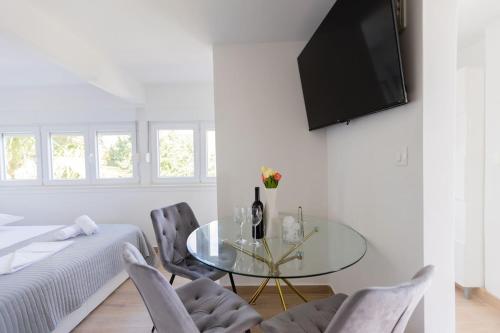 a living room with a glass table and chairs at Digital Nomad Friends in Split