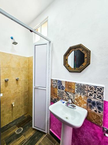 a bathroom with a sink and a mirror at Maya Dreams Bacalar in Bacalar