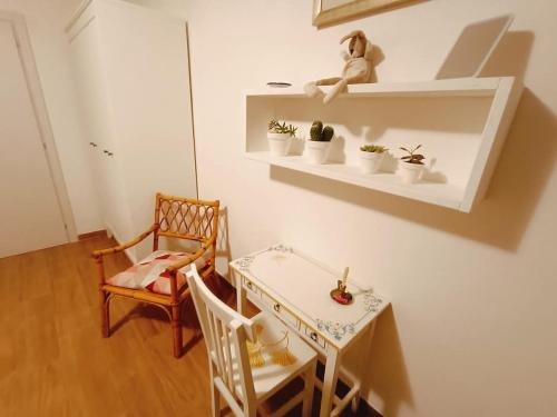 a white room with a table and chairs and a table and a table at Casa Il Ghiro in Monterone