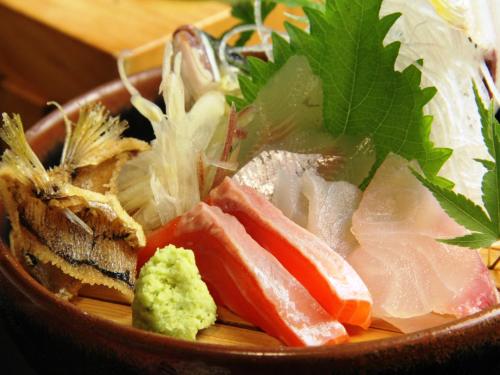 a bowl of food with vegetables on a table at Iwasu-so in Nakatsugawa