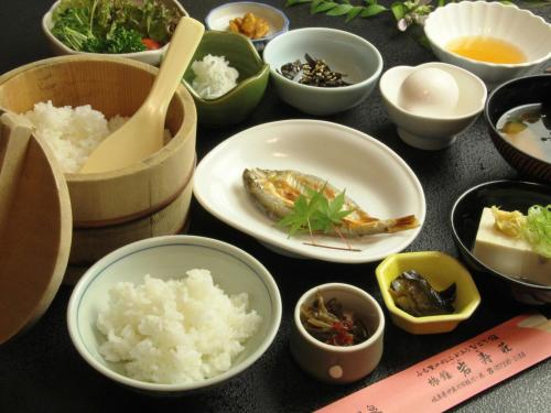 a table with bowls and plates of food on it at Iwasu-so in Nakatsugawa