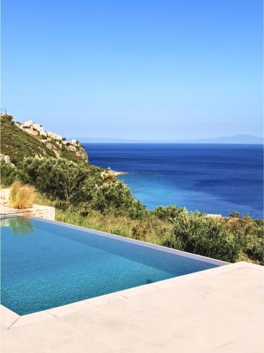 a swimming pool with a view of the ocean at Eleonas Limeni in Limeni