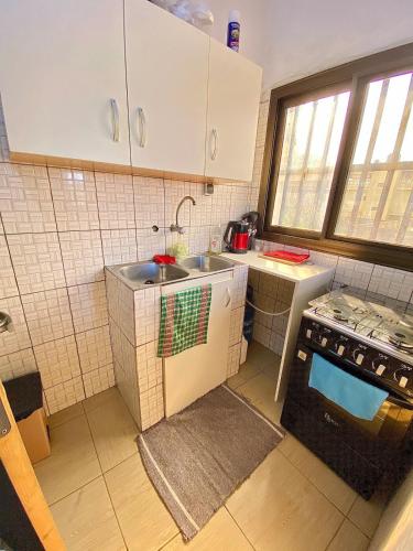 a small kitchen with a sink and a stove at Cozy or almost in Atchavé