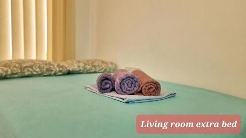 two towels sitting on top of a bed at CSS Cozy Smart Superior Seaview in Tala