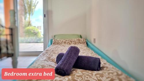 a bed with two towels on it with a room extra bed at CSS Cozy Smart Superior Seaview in Tala