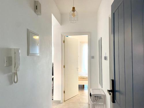 a white hallway with a washer and dryer at CSS Cozy Smart Superior Seaview in Tala