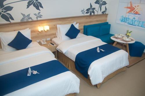 A bed or beds in a room at Azalea Hotels & Residences Boracay