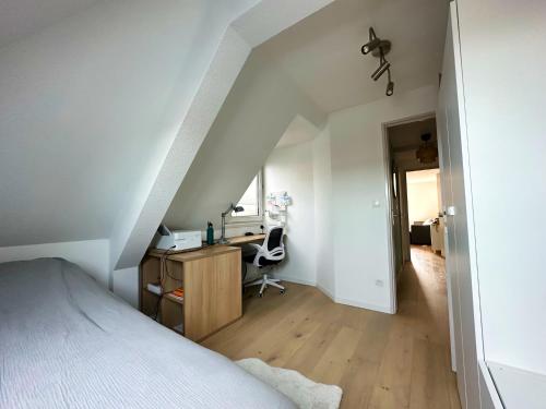 - une chambre mansardée avec un lit et un bureau dans l'établissement T2, Proxi centre, Wifi, Parking Gratuit, 4 pers, à Lille