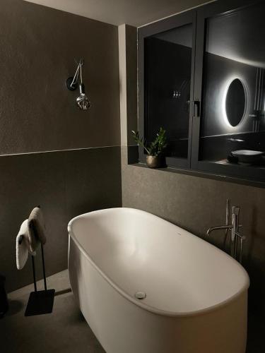 a bathroom with a white bath tub in a room at FeWo Passo-Palade in Tesimo