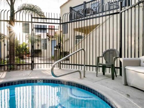 a swimming pool with a chair next to a building at Pacific Plaza #603 - Salty Studio - StudioD-Q in Oceano