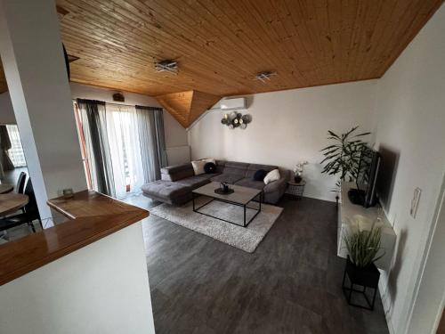 a living room with a couch and a table at Cozy Airport Apartments in Velika Mlaka