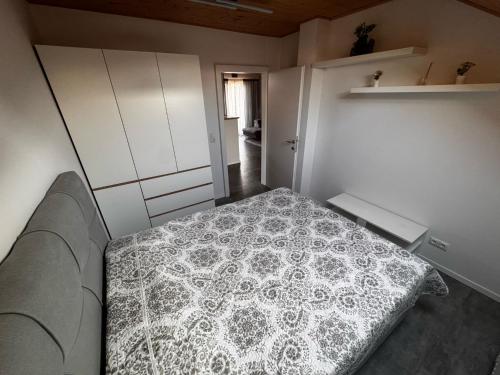 a small bedroom with a bed in a room at Cozy Airport Apartments in Velika Mlaka