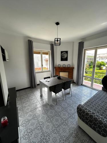 a living room with a table and a bed at Reversal apartment in Santa Marinella