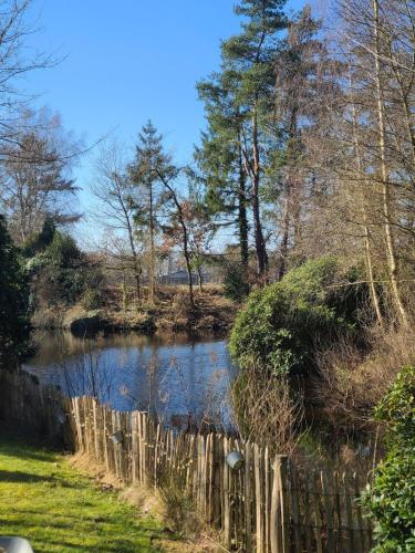 a fence next to a river in a field at Ferienhaus Voigt in Hude