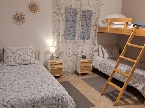 a bedroom with two bunk beds and a ladder at Aegean Villa-On beach apartment! Ideal choice! in Masouri