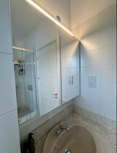 a bathroom with a sink and a mirror at SWeET LEMON VILLA in Protaras