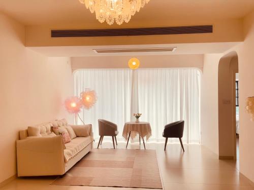 a living room with a couch and a table at 笑涡SmileNest Downtown Luxury Suite for 2-10 Guests, Zhangjiajie Attraction Ticket Service, Ideal for Couples, Families & Groups in Zhangjiajie