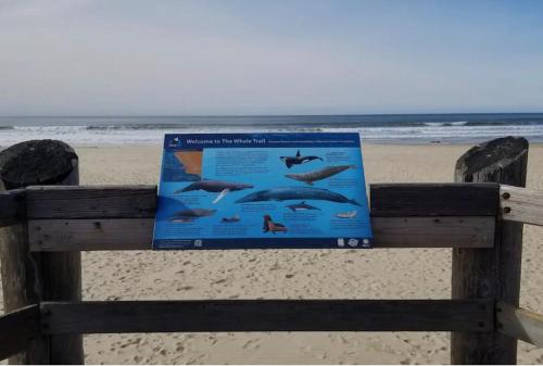 a sign on a fence at the beach at Pacific Plaza #511 - Oceano Escape - 1BdrmUp-K-QSofa in Oceano