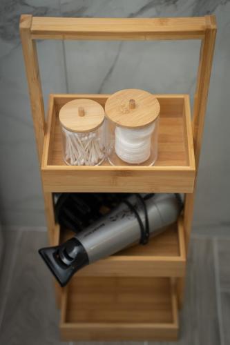 a wooden shelf with a bottle of wine at Lotza apartments in Vrontados